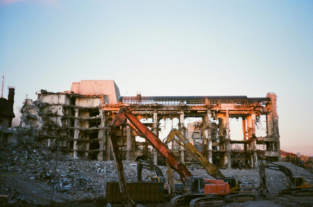 pexels-photo-2327065-2327065 Construction machinery at a building demolition site during sunset.