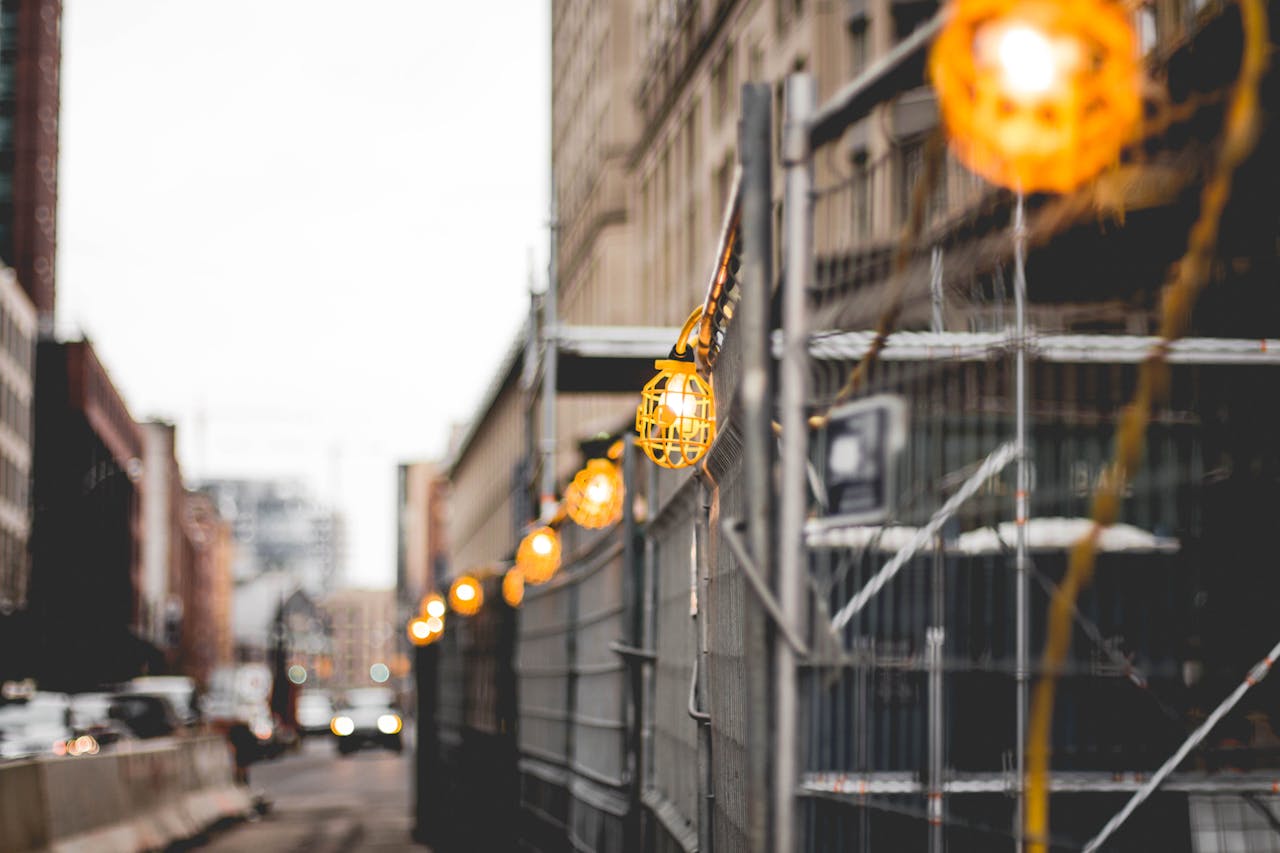 Blurred cityscape of a urban construction site with hanging safety lights in Toronto.